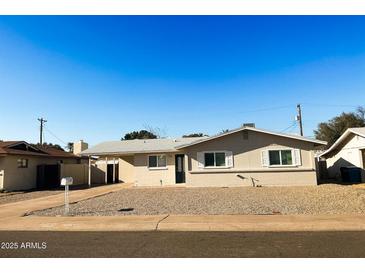Charming single-story home featuring a well-maintained yard and classic architectural details at 3338 W Palmaire Ave, Phoenix, AZ 85051
