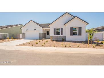 Charming single-Gathering home featuring a two-car garage, tasteful stone accents, and attractive landscaping at 3483 W Sunstone Dr, San Tan Valley, AZ 85144