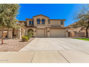 Stunning two-story home featuring a three-car garage and meticulously manicured landscaping at 4725 N 152Nd Dr, Goodyear, AZ 85395