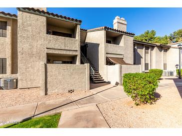 Charming two-story condo with a stucco exterior, stairway access, and desert landscaping at 533 W Guadalupe Rd # 1001, Mesa, AZ 85210
