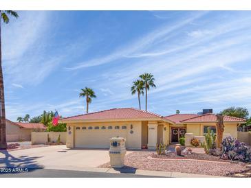 Charming single-story home featuring a well-manicured desert landscape and a red tile roof under a sunny sky at 25850 S Foxglenn Dr, Sun Lakes, AZ 85248