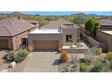 Stunning exterior view of the home with a desert landscape and a two car garage at 32835 N 70Th St, Scottsdale, AZ 85266