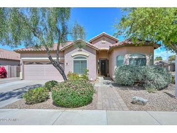 Charming single-story home with a landscaped front yard, beautiful bushes and mature tree at 4306 W Summerside Rd, Laveen, AZ 85339