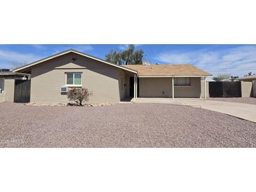 Charming single-story home with low-maintenance landscaping and covered porch at 4924 W Catalina Dr, Phoenix, AZ 85031