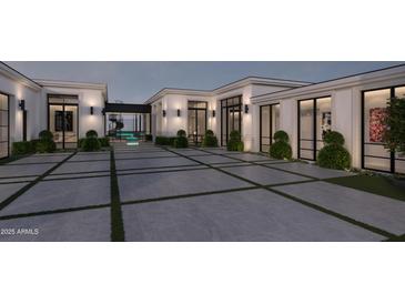 A modern home showcasing a courtyard with elegant landscaping and large windows at 7646 E Hidden Canyon St, Mesa, AZ 85207