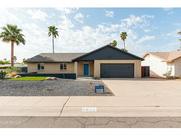 Charming single-story home with a brick facade, well-maintained landscaping, and a two-car garage at 8621 E Vista Dr, Scottsdale, AZ 85250