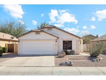 Charming single-story home featuring a two-car garage and low-maintenance desert landscaping at 2123 E Catclaw St, Gilbert, AZ 85296