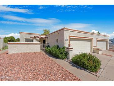 Charming single-story home with a desert landscape, covered entryway, and two-car garage, offering a welcoming curb appeal at 2844 W Christy Dr, Phoenix, AZ 85029