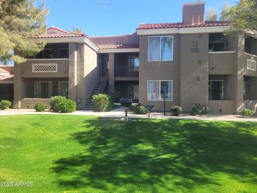 Well-maintained two-story apartment complex with lush green lawn and desert landscaping in a desirable community setting at 2929 W Yorkshire Dr # 2118, Phoenix, AZ 85027