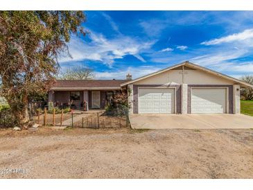 Charming single-story home with a two-car garage and desert landscaping at 3137 W Baseline Rd, Laveen, AZ 85339