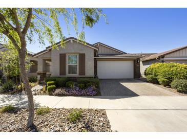Charming single-story home with a well-maintained lawn and a two-car garage at 5854 S Del Rancho --, Mesa, AZ 85212
