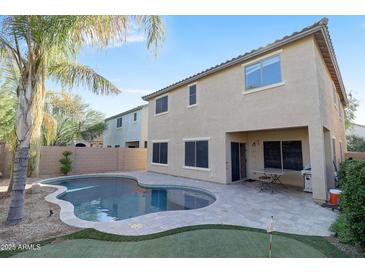 Backyard pool with palm trees, putting green and beautiful desert landscaping at 9009 S 57Th Dr, Laveen, AZ 85339