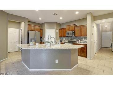 Stylish kitchen with stainless steel appliances, granite countertops, and ample cabinet space at 9009 S 57Th Dr, Laveen, AZ 85339