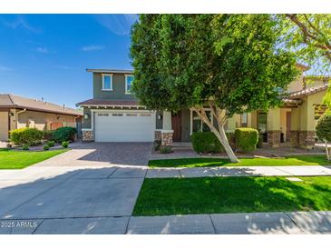 Charming two-story home with a well-maintained front yard and a two-car garage at 4059 E Mesquite St, Gilbert, AZ 85296