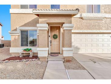Inviting front entrance with a decorated door, leading to a charming home with well-manicured landscaping at 1309 E Daisy Way, San Tan Valley, AZ 85143