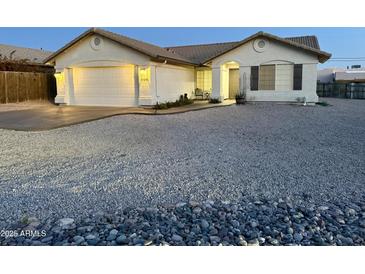 Charming single-story home featuring a two-car garage and low-maintenance desert landscaping at 10241 E La Palma Ave, Gold Canyon, AZ 85118