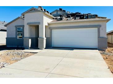 Charming single-story home with gray stucco, concrete driveway, and attached two-car garage awaiting roof tiles at 11959 E Aster Ln, Florence, AZ 85132