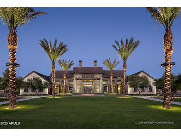 Stately clubhouse entrance with manicured lawn and palm trees, exuding luxury and community at 1948 W Rowel Rd, Phoenix, AZ 85085