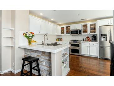 Bright kitchen featuring white cabinets, stainless steel appliances, and tile countertops at 33550 N Dove Lakes Dr # 1041, Cave Creek, AZ 85331