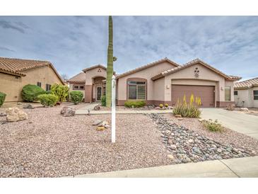 Charming single-story home featuring desert landscaping, a two-car garage, and neutral color palette at 5289 S Red Yucca Ln, Gold Canyon, AZ 85118
