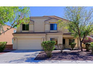 Two-story home with a neutral color palette, well-maintained landscaping, and attached two-car garage at 9541 W Frank Ave, Peoria, AZ 85382
