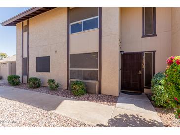 Charming two-story home featuring a front door with security screen and well-maintained landscaping at 17808 N 45Th Ave, Glendale, AZ 85308