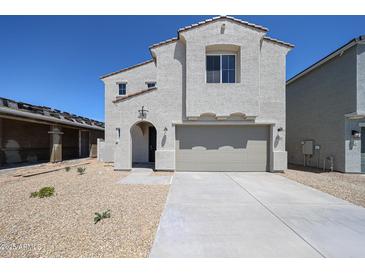 Charming two-story home with a two-car garage and a low-maintenance gravel front yard at 18244 W Daley Ln, Surprise, AZ 85387