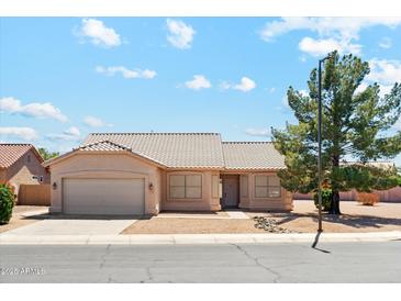 Charming single-story home featuring a tile roof, desert landscaping, and a two-car garage on a sunny day at 1245 E Waterview Pl, Chandler, AZ 85249