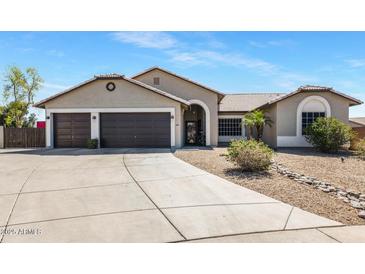 Charming single-story home with a three-car garage and a well-maintained front yard at 4115 S 75Th Dr, Phoenix, AZ 85043