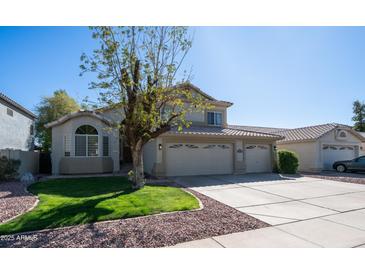 Charming two-story home featuring a three-car garage, landscaped yard, and a welcoming entrance at 843 W Palo Verde St, Gilbert, AZ 85233