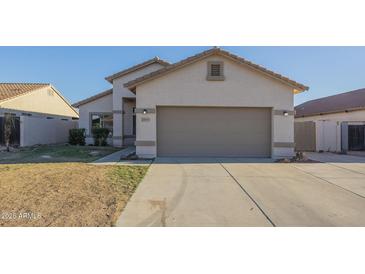Charming single-story home with a two-car garage and low maintenance desert landscaping at 11835 W Windsor Ave, Avondale, AZ 85392