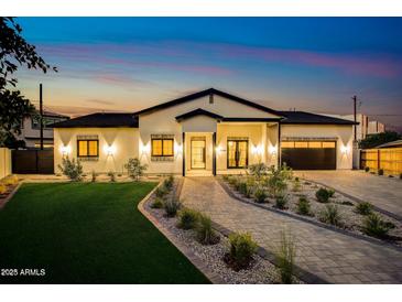 Stunning single-story home with professional landscaping, brick driveway, and welcoming modern curb appeal at 1506 E Tuckey Ln, Phoenix, AZ 85014