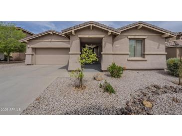 Inviting single-story home with neutral stucco exterior and desert landscaping, offering great curb appeal at 16526 W Calle Lejos --, Surprise, AZ 85387