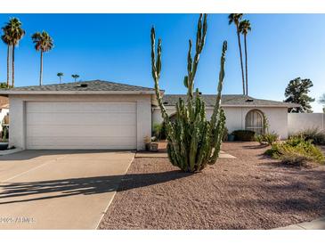 Charming single-story home featuring desert landscaping, a two-car garage, and a well-maintained facade at 2717 W Medina Ave, Mesa, AZ 85202