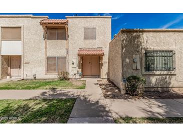 Charming townhome with a traditional desert landscape and cozy front patio at 3113 W Royal Palm Rd, Phoenix, AZ 85051