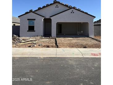 A single-story stucco house with an attached two-car garage featuring a tiled roof and low water use landscaping at 3945 E San Jose St, San Tan Valley, AZ 85143
