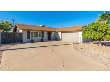 Charming single-story home with a well-maintained front yard and a spacious driveway at 8656 E Plaza Ave, Scottsdale, AZ 85250