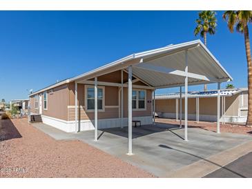 Charming single-level home featuring a spacious carport and well-maintained landscaping at 9431 E Coralbell Ave # 178, Mesa, AZ 85208