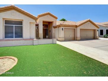 Charming single-Gathering home with a two-car garage and well-manicured lawn at 1347 W Straford Ave, Gilbert, AZ 85233