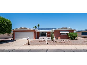 Charming home featuring desert landscaping, solar panels, and an attached two-car garage at 6258 E Duncan St, Mesa, AZ 85205