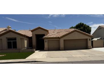Charming one-story home with tile roof, desert landscaping, and a two car garage at , Gilbert, AZ 85233