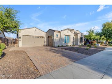 Charming single story home featuring a three car garage and desert landscaping at 21325 S 201St Way, Queen Creek, AZ 85142