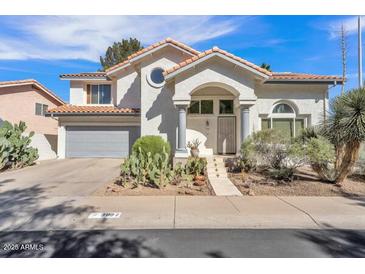 Charming home featuring a two-car garage and desert landscaping in a well-maintained front yard at 3932 W Rene Dr, Chandler, AZ 85226
