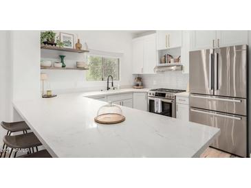 Bright kitchen with white cabinets, stainless steel appliances, and quartz countertops at 5450 E Deer Valley Dr # 2003, Phoenix, AZ 85054