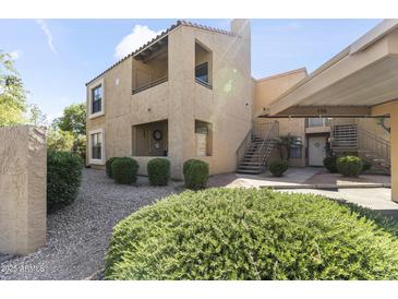 A charming condo featuring well-maintained landscaping and a two-story exterior design with private balconies at 8787 E Mountain View Rd # 2016, Scottsdale, AZ 85258