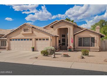 Charming single-story home featuring a three-car garage and desert landscaping at 10804 W Mohawk Ln, Peoria, AZ 85373