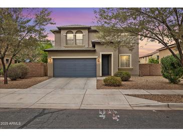 Charming two-story home with a well-maintained front yard and a two-car garage at 15758 W Cortez St, Surprise, AZ 85379