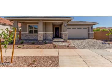 Charming single-story home with a well-manicured yard and inviting stone-accented facade at 21829 E Bonanza Ct, Queen Creek, AZ 85142