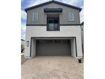Two-story home with a two-car garage and a balcony on the second floor at 2470 W Rowel Rd, Phoenix, AZ 85085