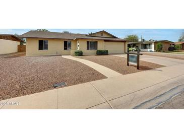 Charming single-story home with a well-maintained front yard and a welcoming walkway at 1619 E Del Rio Dr, Tempe, AZ 85282